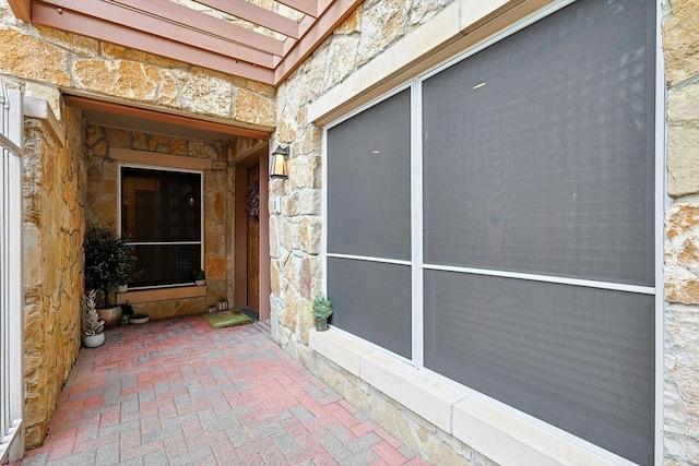 property entrance featuring stone siding