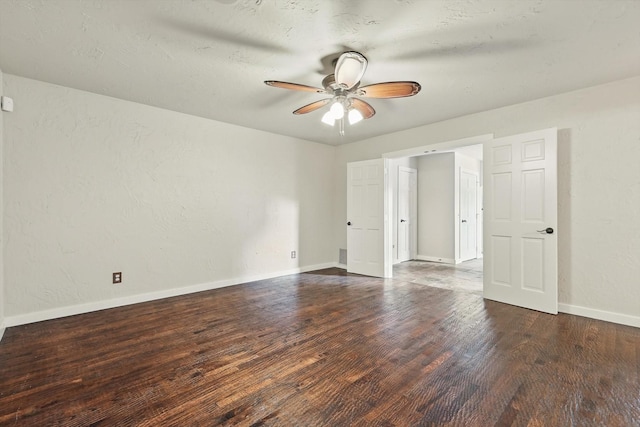 spare room featuring visible vents, baseboards, wood finished floors, and ceiling fan