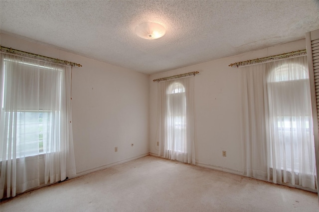 1001 S Sutton St, Mabank, TX 75147 - carpeted empty room with baseboards and a textured ceiling
