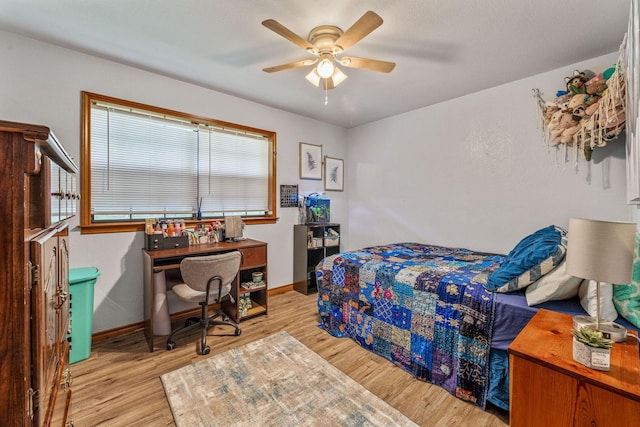 bedroom with wood finished floors, ceiling fan, and baseboards