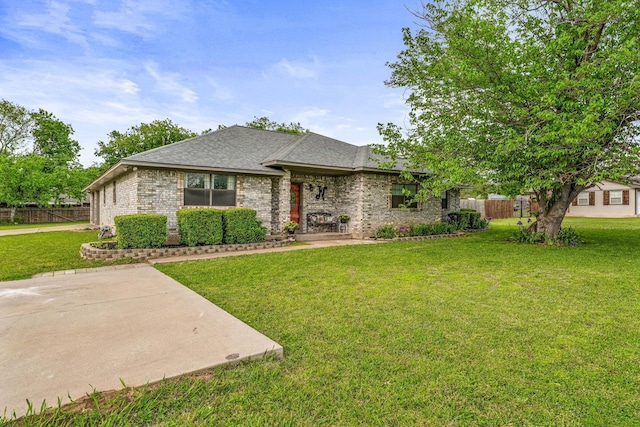 single story home featuring a front yard, brick siding, and fence