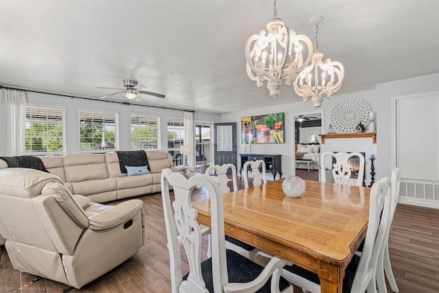 868 Briggs Blvd, East Tawakoni, TX 75472 - dining area featuring a wealth of natural light, visible vents, ceiling fan with notable chandelier, and wood finished floors