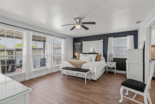 868 Briggs Blvd, East Tawakoni, TX 75472 - bedroom featuring multiple windows, wood finished floors, and a textured ceiling