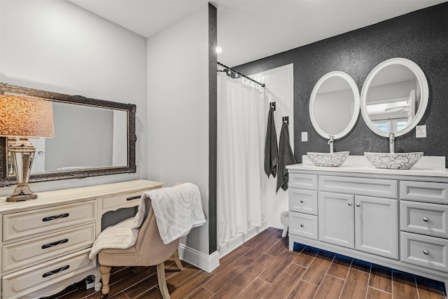 868 Briggs Blvd, East Tawakoni, TX 75472 - full bathroom with curtained shower, wood finished floors, vanity, and a textured wall