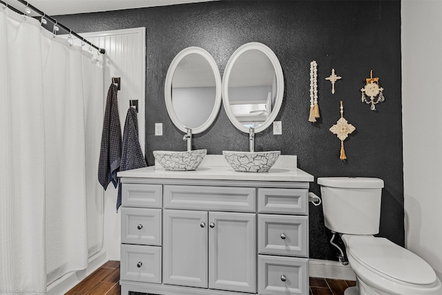 868 Briggs Blvd, East Tawakoni, TX 75472 - bathroom with toilet, wood finished floors, a textured wall, and baseboards