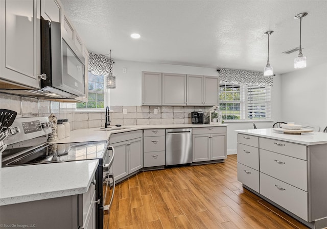 868 Briggs Blvd, East Tawakoni, TX 75472 - kitchen with a sink, plenty of natural light, gray cabinetry, and stainless steel appliances