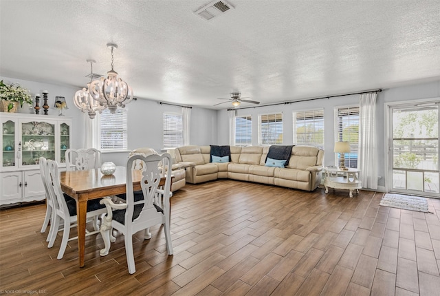 868 Briggs Blvd, East Tawakoni, TX 75472 - dining space with dark wood-type flooring, visible vents, and a textured ceiling