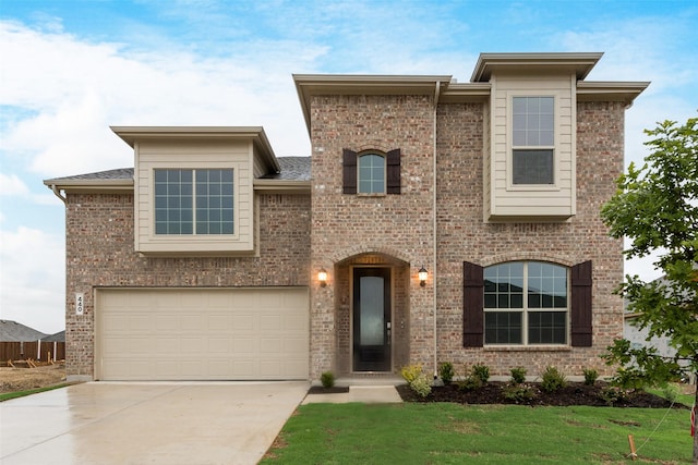 440 Lone Star Dr, Justin, TX 76247 - view of front of house with concrete driveway, a garage, a front lawn, and brick siding