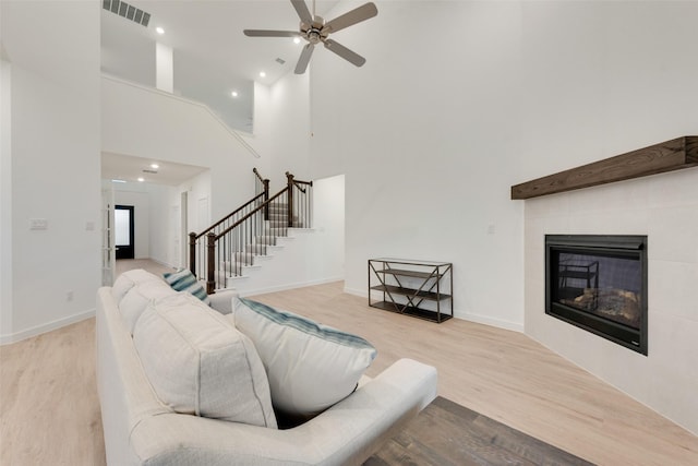 440 Lone Star Dr, Justin, TX 76247 - living area featuring wood finished floors, visible vents, stairway, a towering ceiling, and ceiling fan