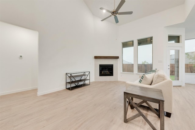 440 Lone Star Dr, Justin, TX 76247 - living area featuring ceiling fan, light wood-style flooring, high vaulted ceiling, and a tile fireplace