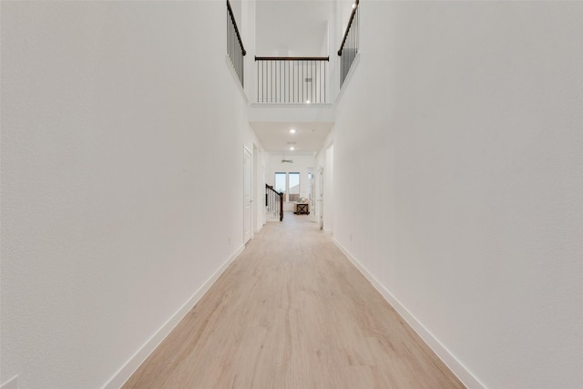 440 Lone Star Dr, Justin, TX 76247 - corridor with light wood finished floors, a towering ceiling, and baseboards