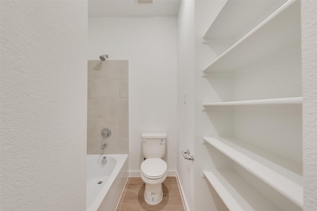 440 Lone Star Dr, Justin, TX 76247 - bathroom with toilet, shower / washtub combination, visible vents, a textured wall, and baseboards
