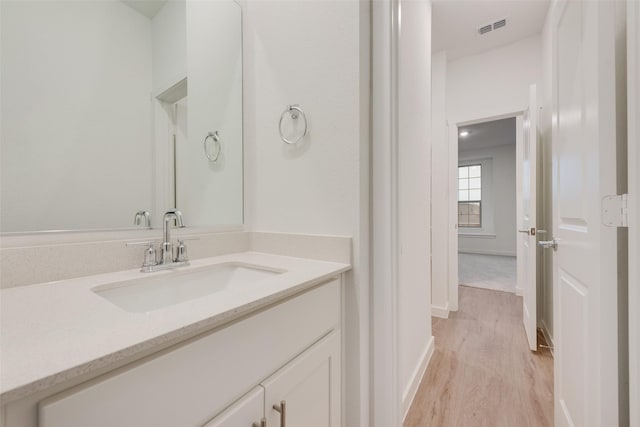 440 Lone Star Dr, Justin, TX 76247 - bathroom featuring baseboards, vanity, visible vents, and wood finished floors