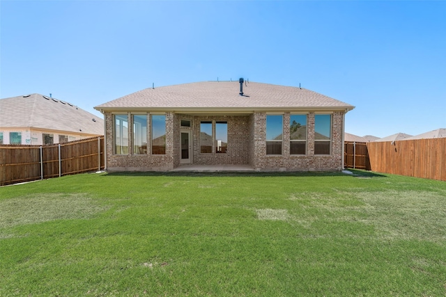 440 Lone Star Dr, Justin, TX 76247 - back of house featuring a lawn, brick siding, and a fenced backyard