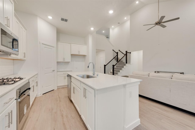 440 Lone Star Dr, Justin, TX 76247 - kitchen with a sink, appliances with stainless steel finishes, open floor plan, visible vents, and light wood-style floors