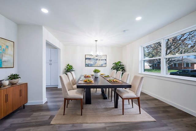 dining area with dark wood-style flooring, an inviting chandelier, baseboards, and recessed lighting