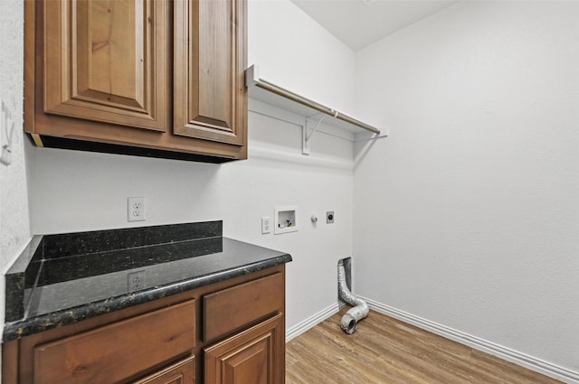 512 Hidden Springs Trl, Azle, TX 76020 - clothes washing area with electric dryer hookup, light wood-style floors, hookup for a washing machine, baseboards, and cabinet space