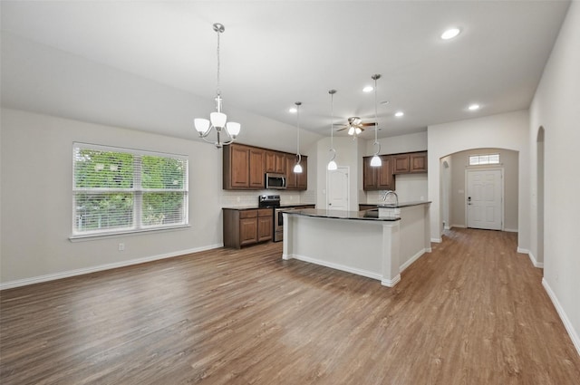 512 Hidden Springs Trl, Azle, TX 76020 - kitchen with appliances with stainless steel finishes, light wood-style flooring, arched walkways, a sink, and open floor plan