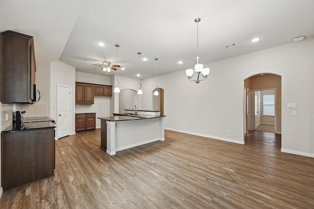 512 Hidden Springs Trl, Azle, TX 76020 - kitchen with arched walkways, dark countertops, ceiling fan, recessed lighting, and dark wood-style flooring