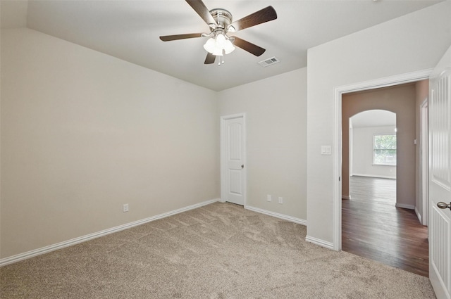 512 Hidden Springs Trl, Azle, TX 76020 - unfurnished bedroom featuring arched walkways, carpet floors, baseboards, and ceiling fan