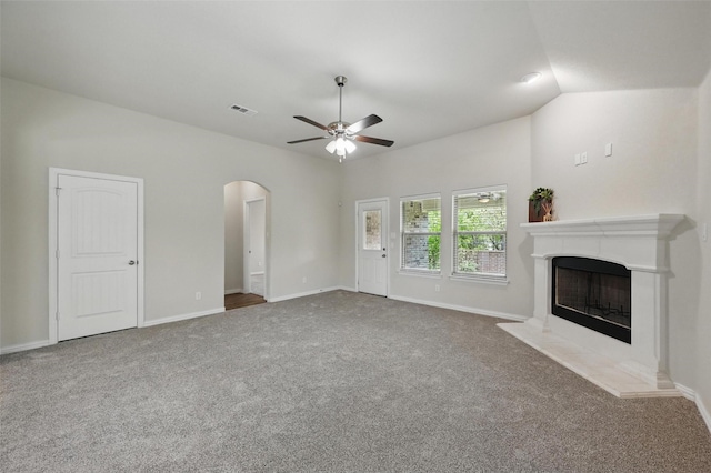 512 Hidden Springs Trl, Azle, TX 76020 - unfurnished living room with arched walkways, ceiling fan, a premium fireplace, carpet, and baseboards