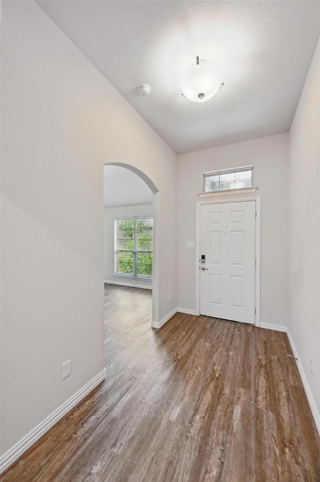 512 Hidden Springs Trl, Azle, TX 76020 - foyer with arched walkways, wood finished floors, and baseboards