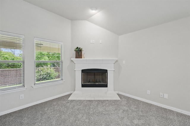 512 Hidden Springs Trl, Azle, TX 76020 - unfurnished living room featuring carpet floors, vaulted ceiling, baseboards, and a tile fireplace
