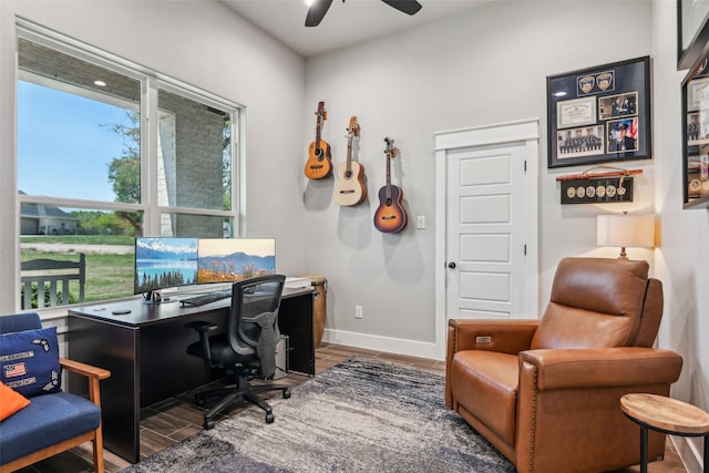 home office featuring baseboards, a ceiling fan, and wood finished floors