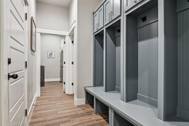 mudroom featuring light wood-style floors and baseboards