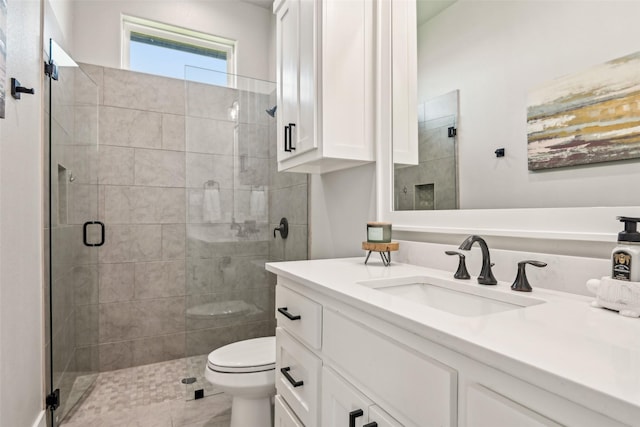 full bathroom with tile patterned floors, toilet, a stall shower, and vanity