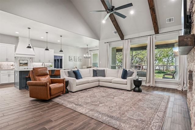 living room featuring visible vents, ceiling fan with notable chandelier, and dark wood finished floors