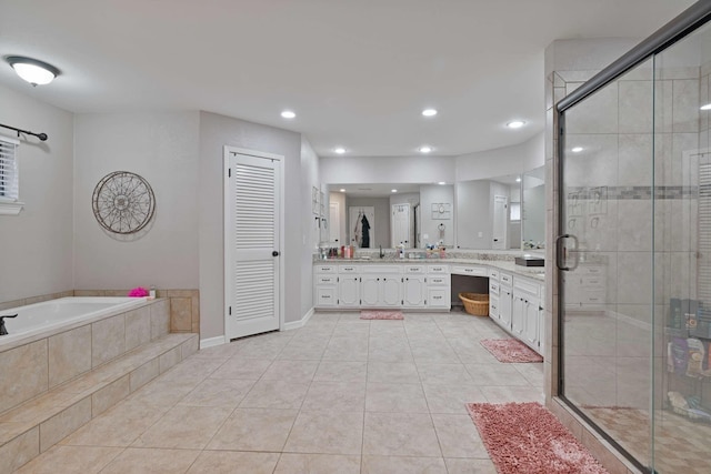 bathroom featuring a shower stall, a garden tub, vanity, and tile patterned flooring