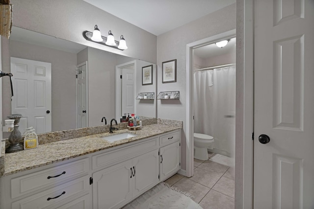 bathroom with toilet, vanity, tile patterned flooring, and a shower with curtain