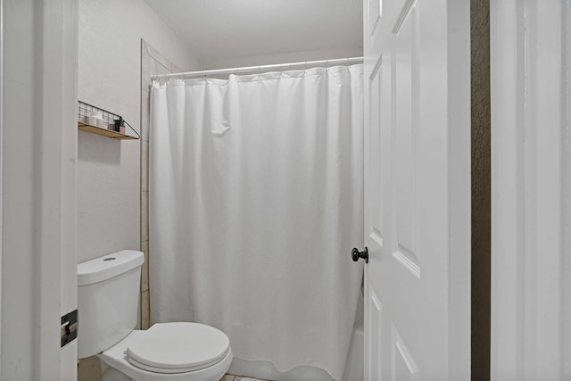 full bathroom with toilet and curtained shower