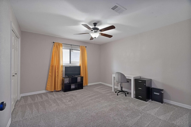 home office with baseboards, a ceiling fan, visible vents, and carpet floors