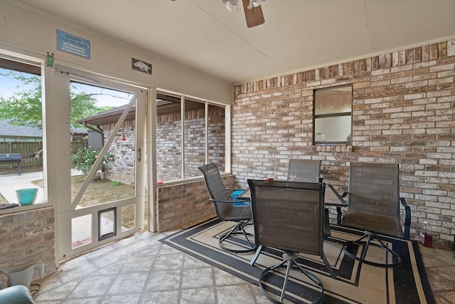 sunroom / solarium featuring outdoor dining space and a ceiling fan