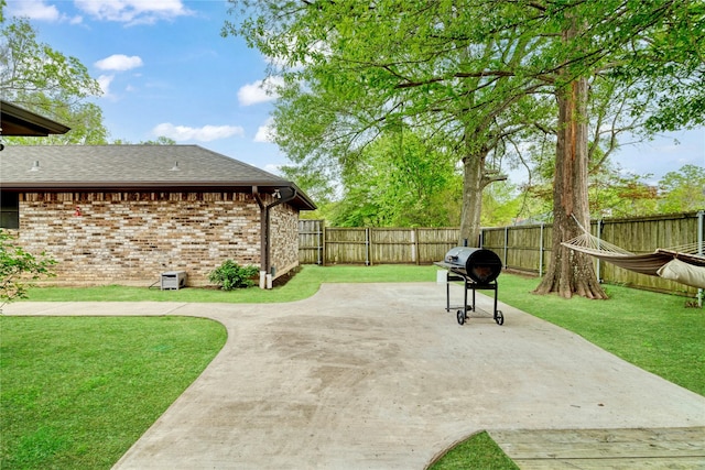 view of patio with a fenced backyard and area for grilling