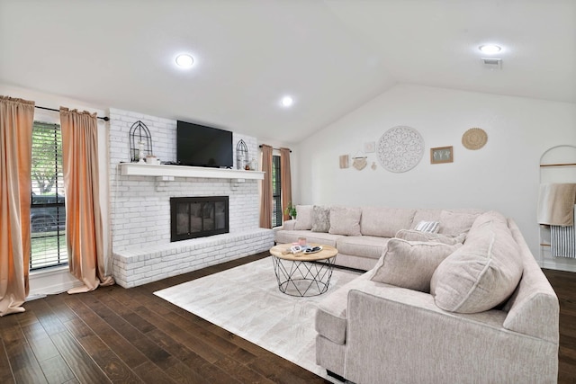 living area featuring visible vents, recessed lighting, vaulted ceiling, dark wood-style flooring, and a brick fireplace