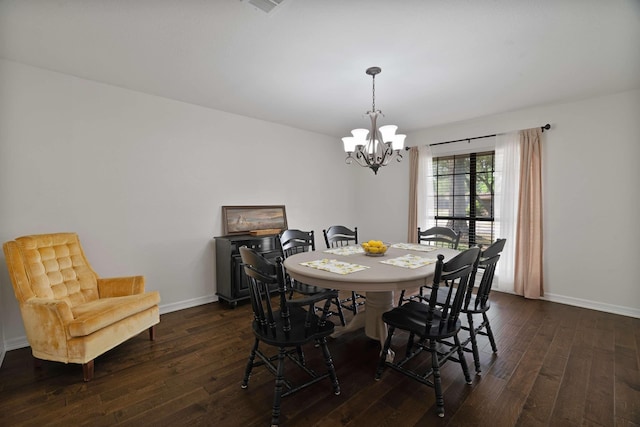 dining room with dark wood-type flooring, an inviting chandelier, and baseboards