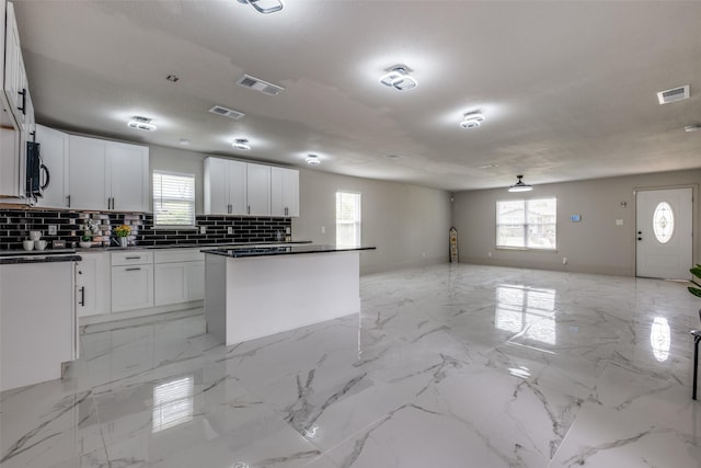 10061 Neosho Dr, Dallas, TX 75217 - kitchen with tasteful backsplash, visible vents, and plenty of natural light