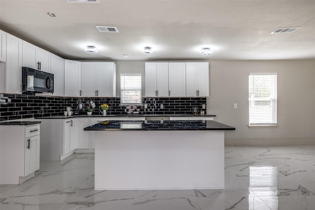 10061 Neosho Dr, Dallas, TX 75217 - kitchen with visible vents, black microwave, and plenty of natural light