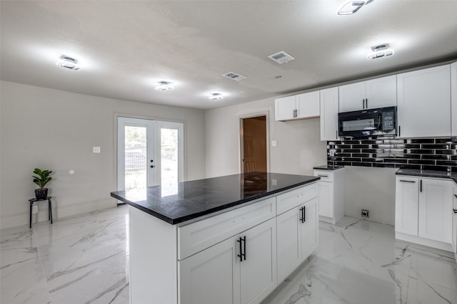 10061 Neosho Dr, Dallas, TX 75217 - kitchen featuring tasteful backsplash, marble finish floor, visible vents, and black microwave