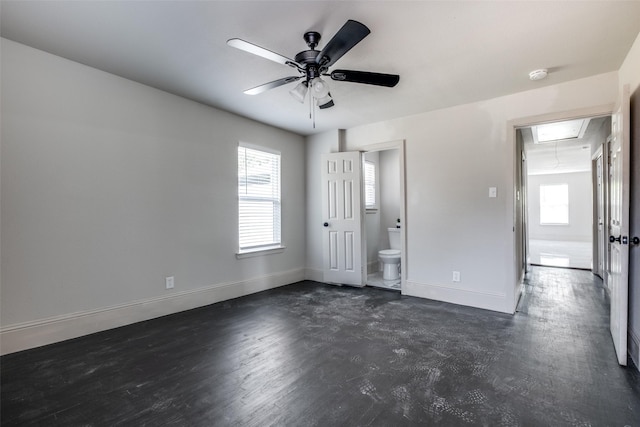 10061 Neosho Dr, Dallas, TX 75217 - unfurnished bedroom featuring baseboards, ensuite bathroom, multiple windows, and attic access