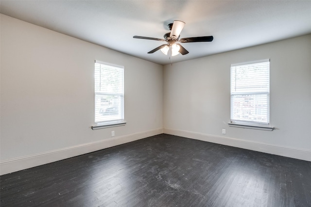 10061 Neosho Dr, Dallas, TX 75217 - empty room featuring dark wood-style flooring, baseboards, and a ceiling fan