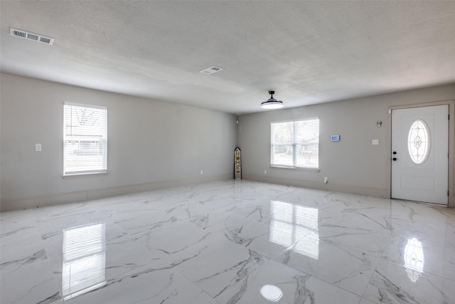 10061 Neosho Dr, Dallas, TX 75217 - interior space with visible vents, baseboards, and a textured ceiling