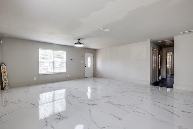 10061 Neosho Dr, Dallas, TX 75217 - unfurnished living room featuring marble finish floor, visible vents, baseboards, and attic access