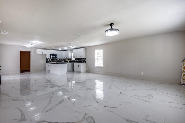 10061 Neosho Dr, Dallas, TX 75217 - unfurnished living room with marble finish floor, visible vents, and baseboards