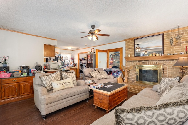living room with crown molding, ceiling fan, a brick fireplace, and dark wood-style flooring