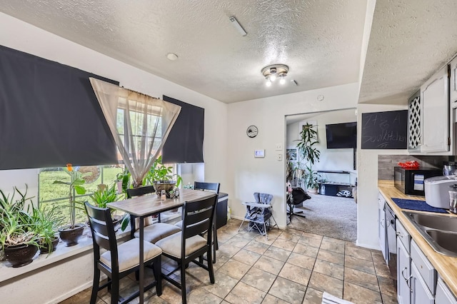 dining area featuring baseboards and a textured ceiling