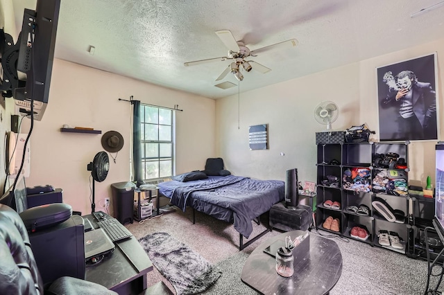 bedroom with carpet, a textured ceiling, and ceiling fan